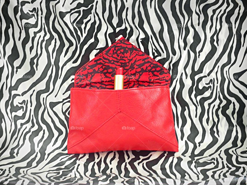 Red lipstick in red bag 