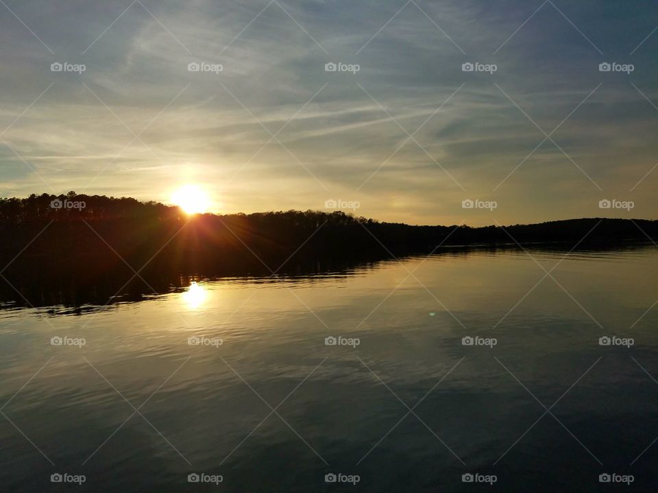 setting sun over island.