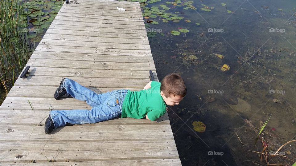 boy on dock. Huron Meadows,  Michigan