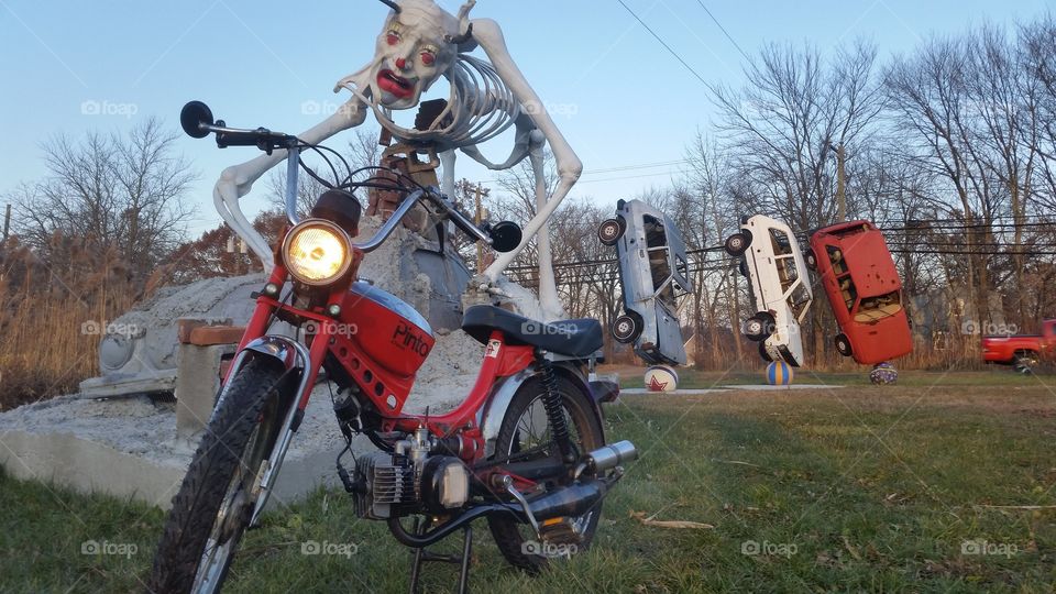 JC PENNEY PINTO MOPED IN FRONT OF ART INSTALLATIONS