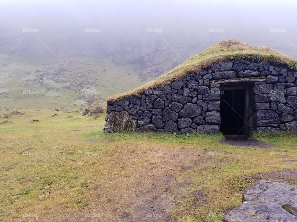Rustic hut on a foggy day on Westman Island, Iceland.