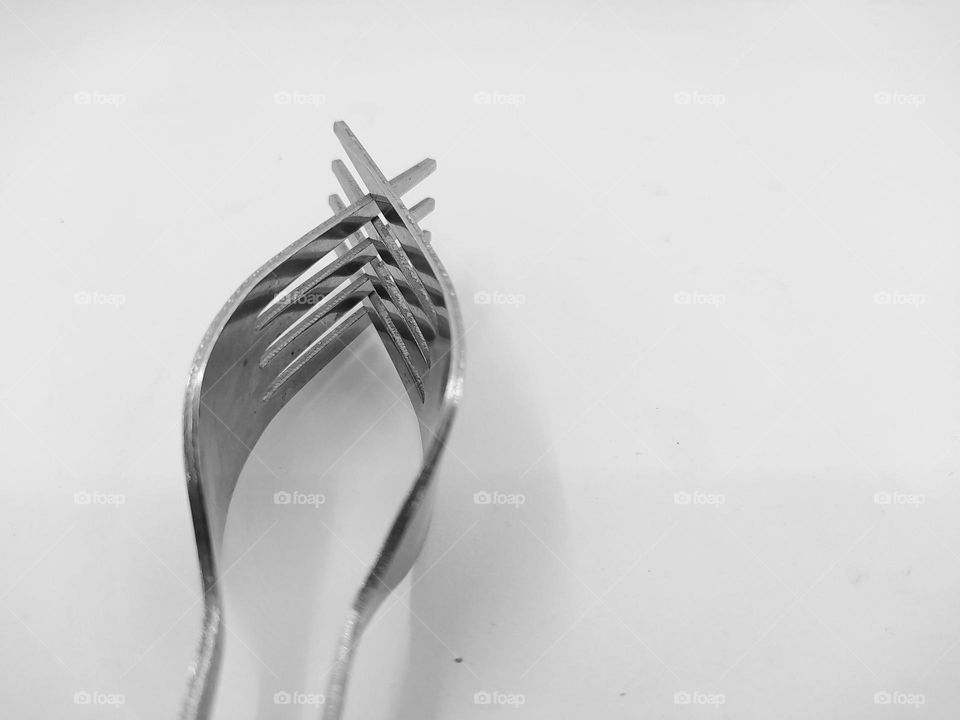 Two forks joined together, isolated on white background