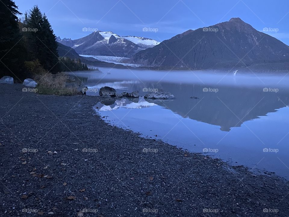Twilight Reflection on Mendenhall lake. Fog line separating frigid water and glorious mountains surrounding the Mendenhall Glacier.