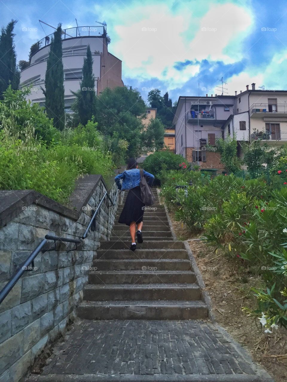 Woman climbing the stairs to town