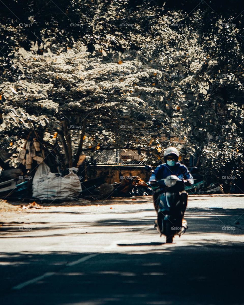 a scooter driving alone a street 