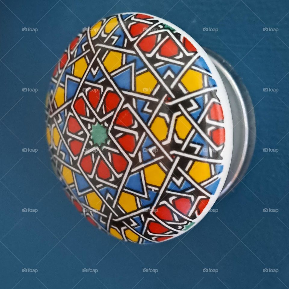 draw handle. colourful. blue. close up. patterned knob