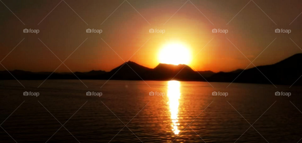Amazing sceneric view of an evening sunset Captured. The entire sky turned into golden.Silhouettes and Shadows.