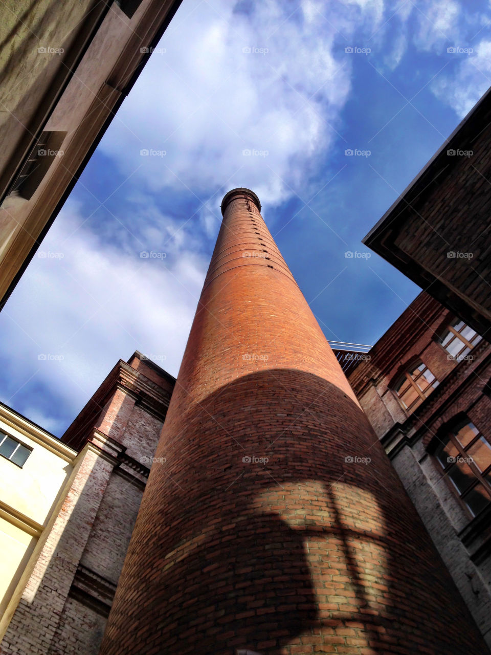 Industrial spire. Factory pipe poking the sky