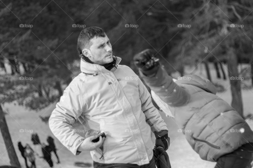 Father and child playing in the snow