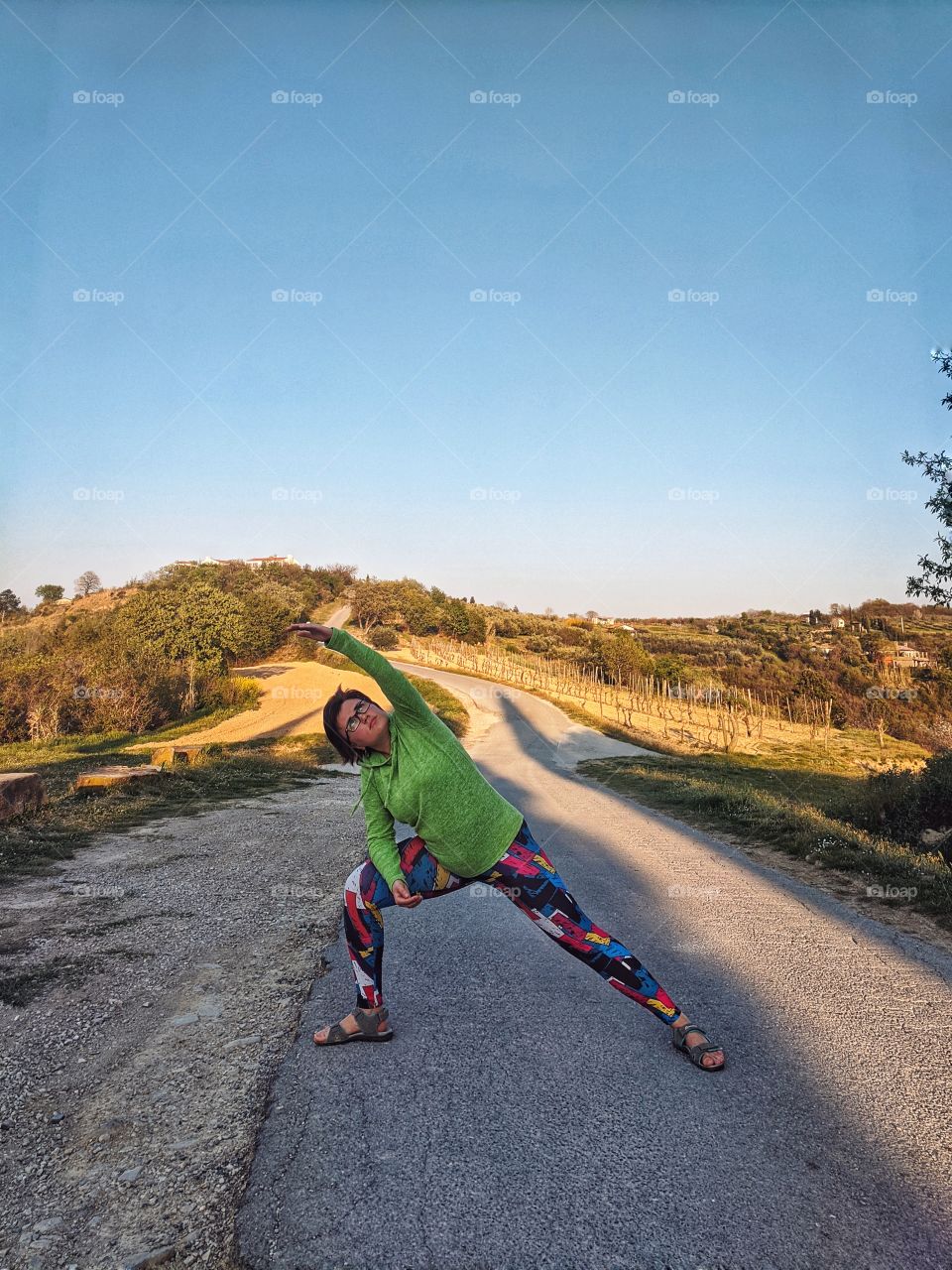Portrait of beautiful young smiling woman doing yoga poses at the nature at spring. Healthy lifestyle.
