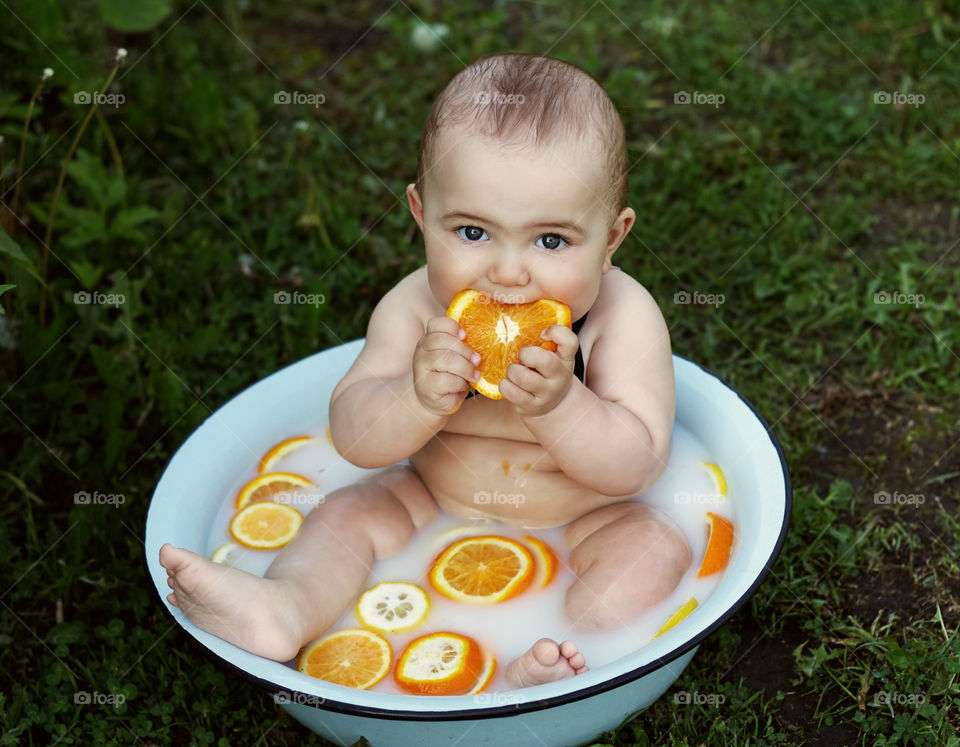 baby bathes in a basin