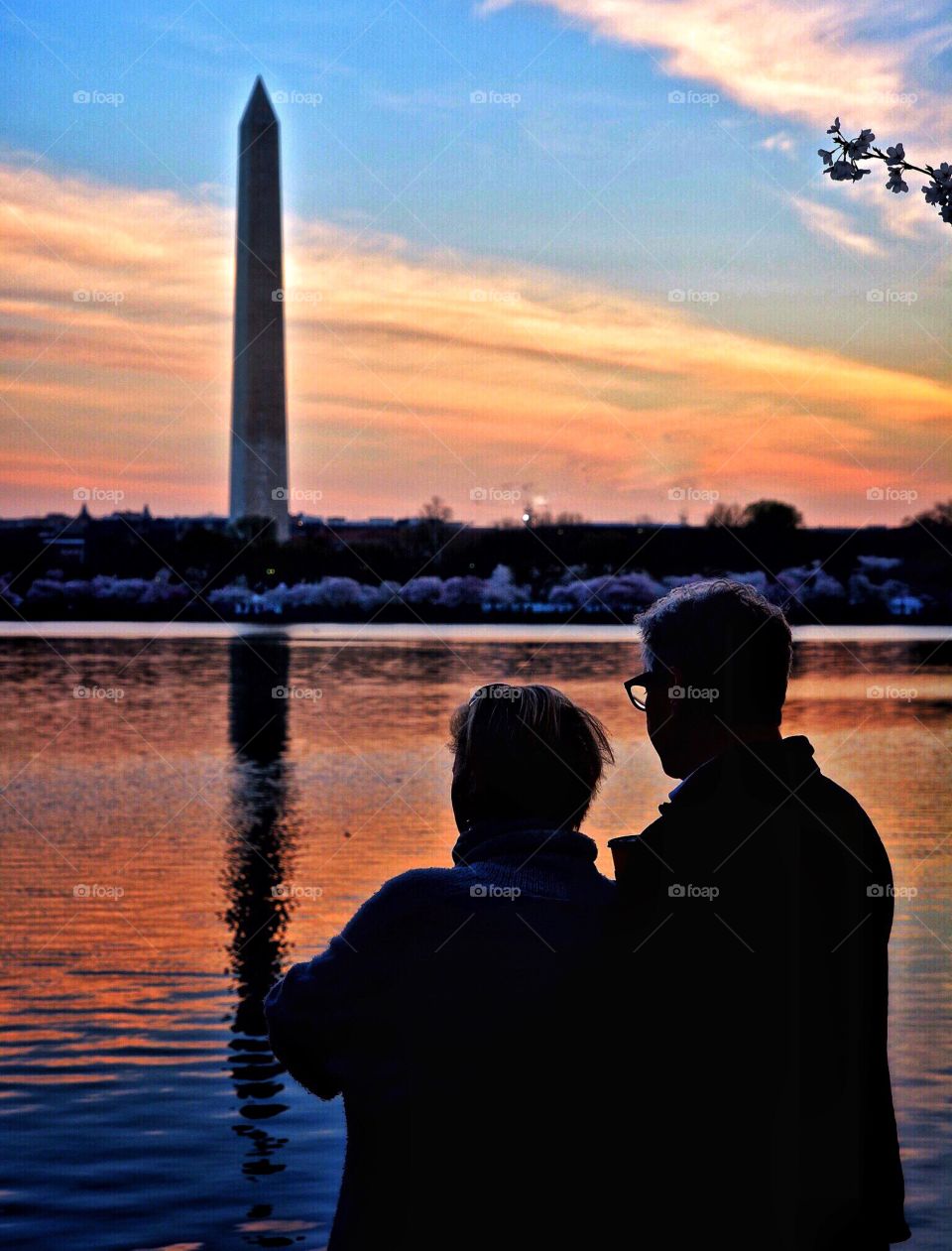 Baby boomer couple at the Washington Monument at sunset