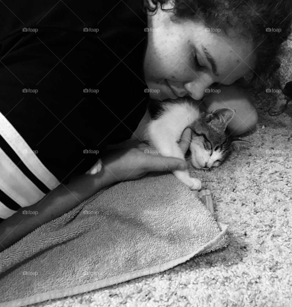 People sleeping on bed with kitten