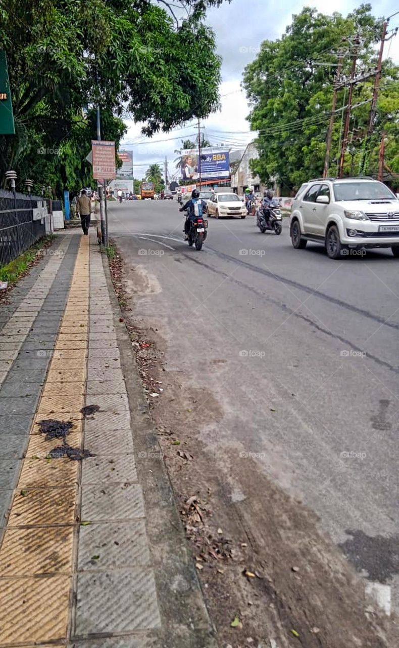 vehicles ride on road through town