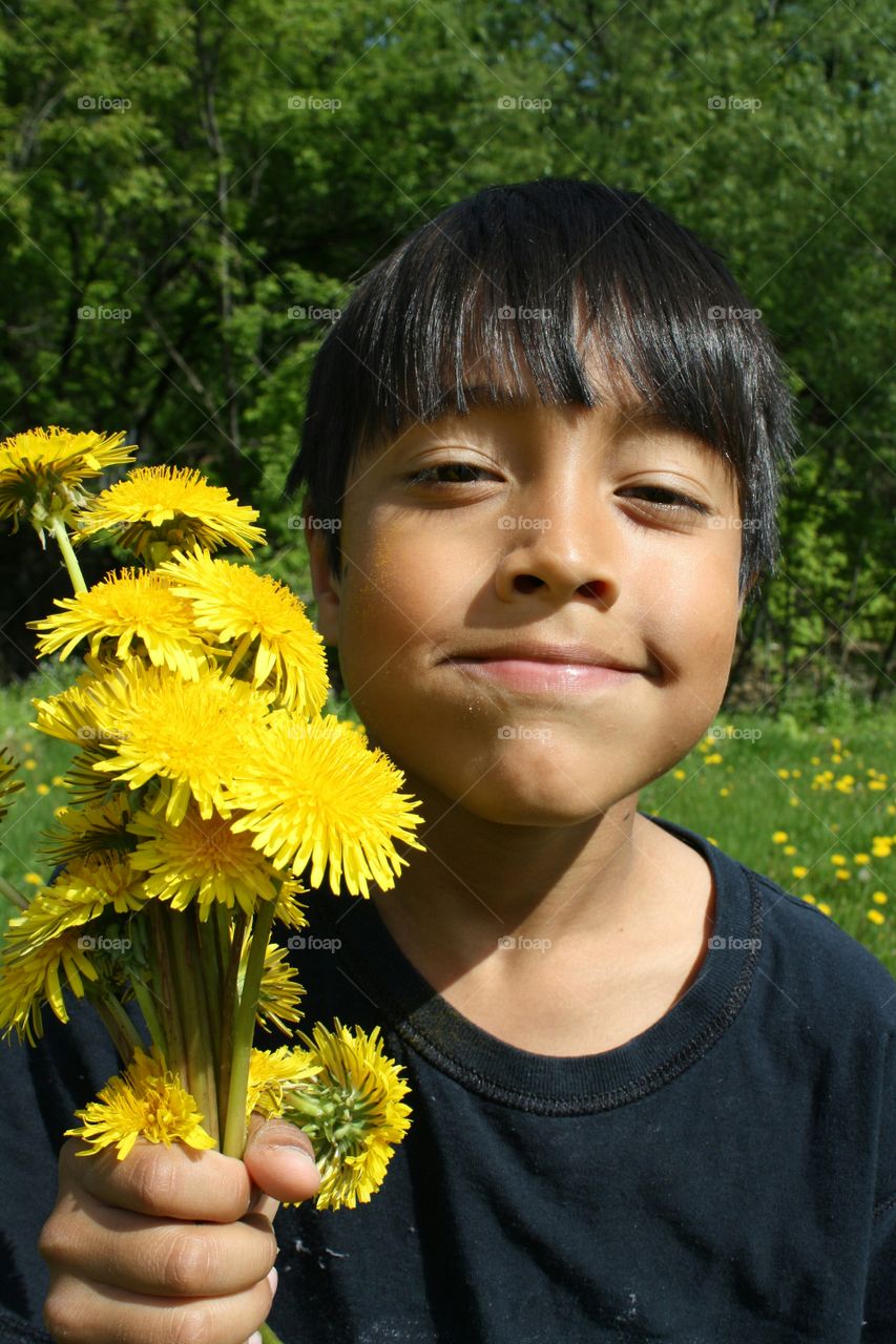 Asian girl holding yellow flower