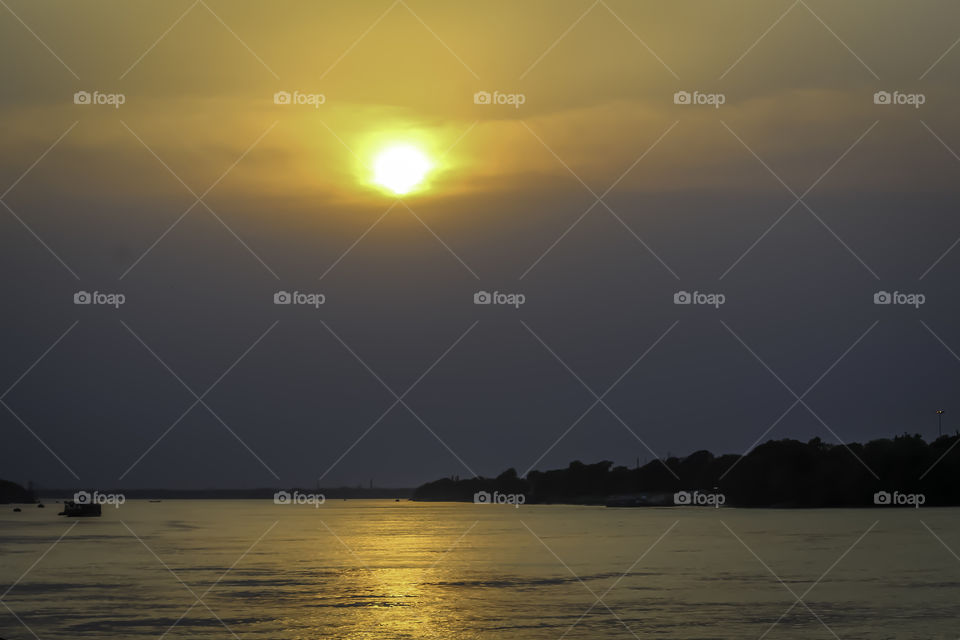 Beautiful sky over the river at sunset or sunrise. Inspirational calm river with sunset sky. Meditation ocean and sky background. Colorful horizon over the water.