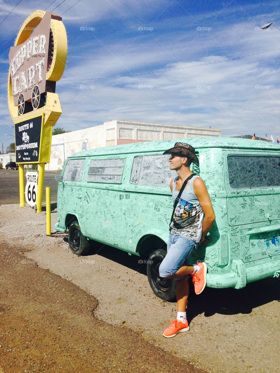 Man is taking a rest beside a written van.
On the route 66