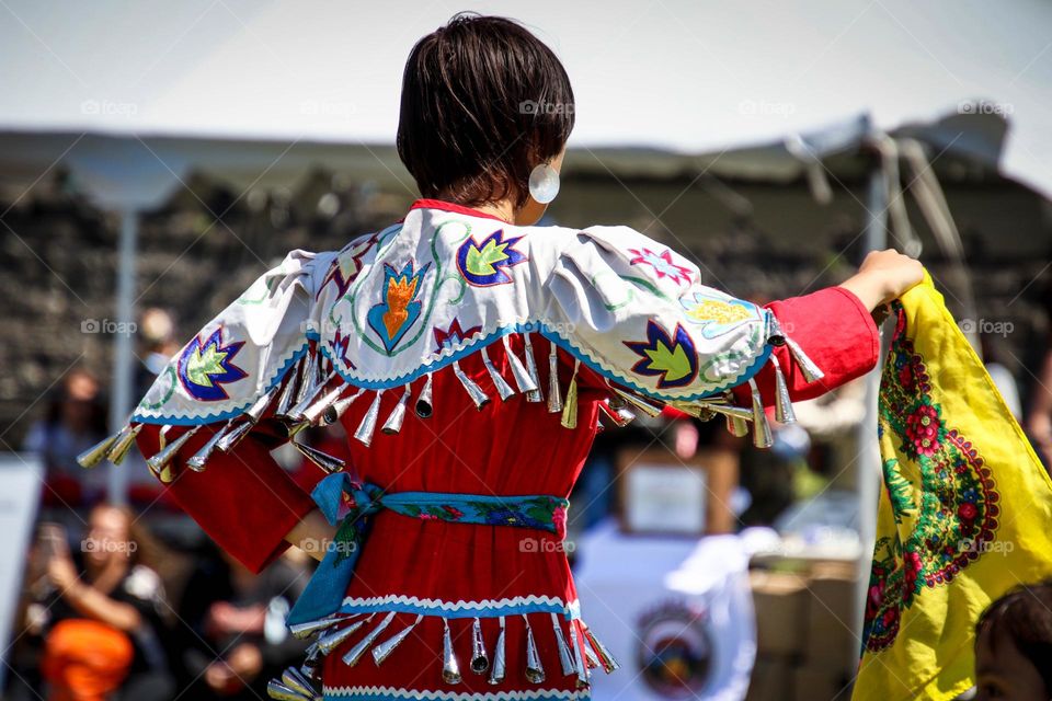 Beautiful lady is performing on a pow wow