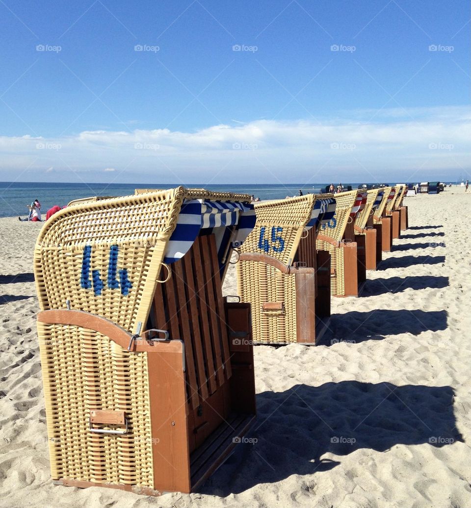 numbered chairs on a beach in Germany on a sunny day