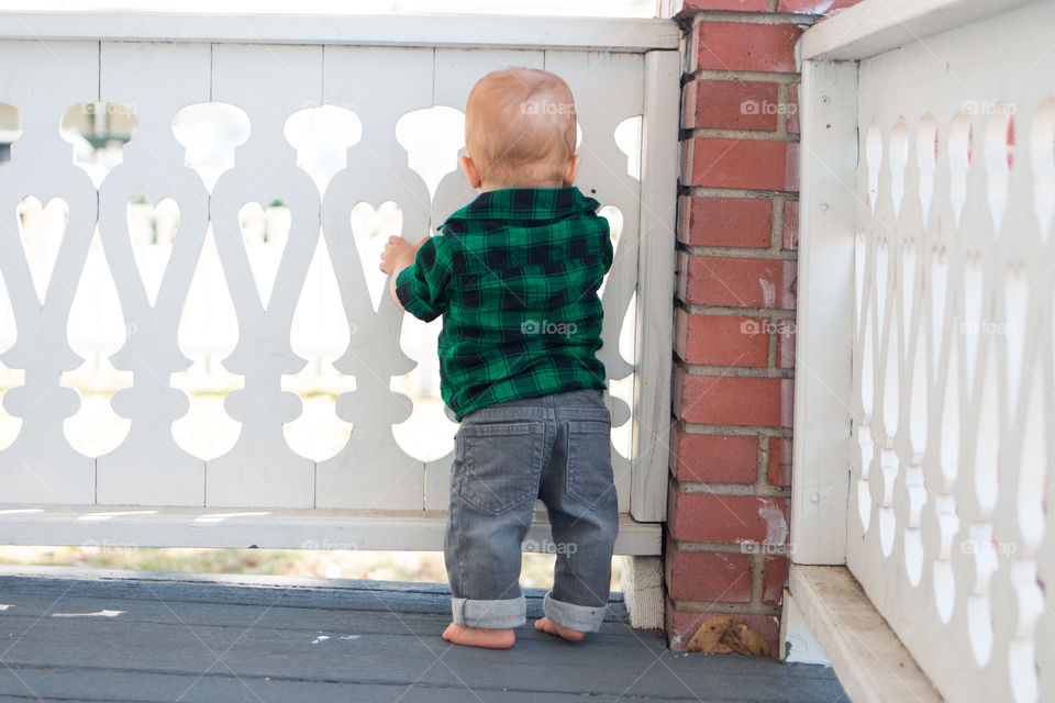 Rear view of a standing baby boy