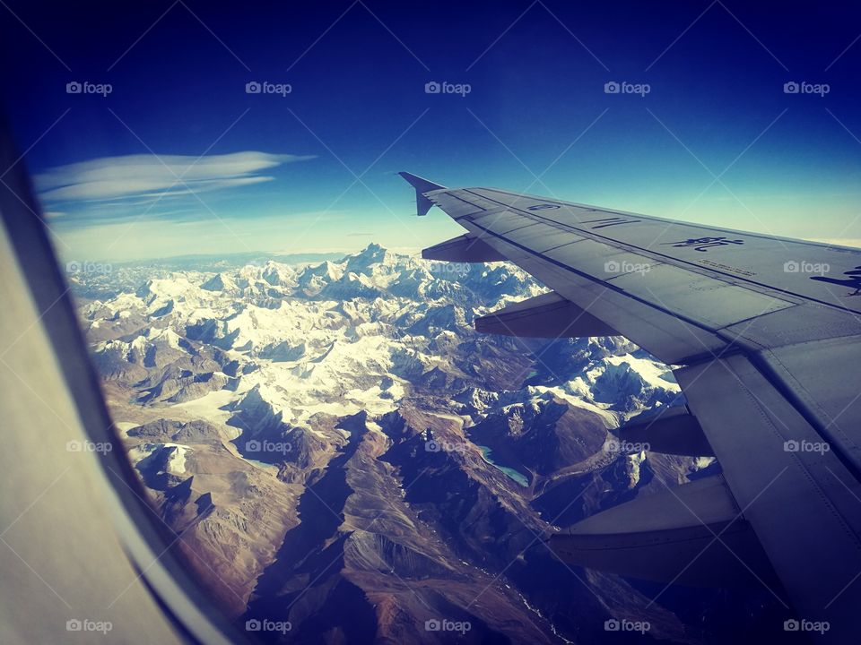 Flying over the Himalayan range with Mt.Everest on the site