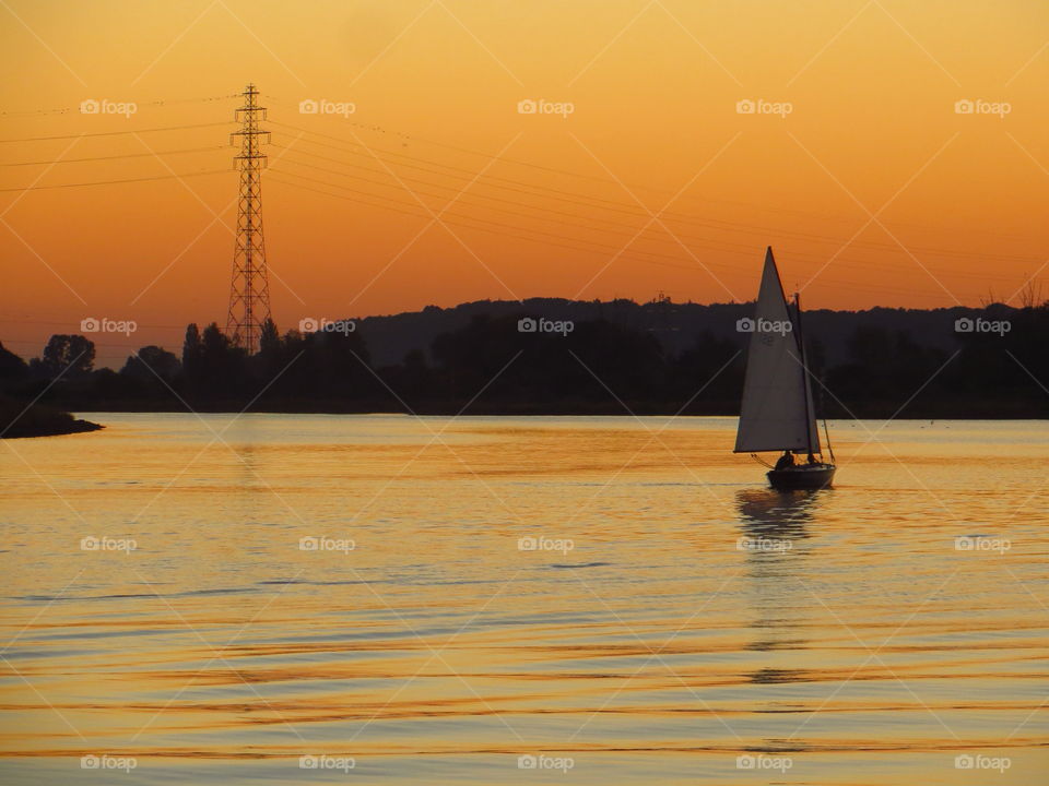 Sailboat in the lake at sunset