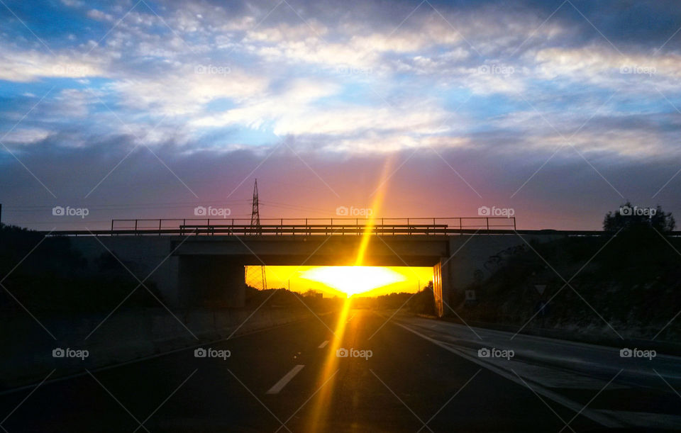 sun reflection under bridge
