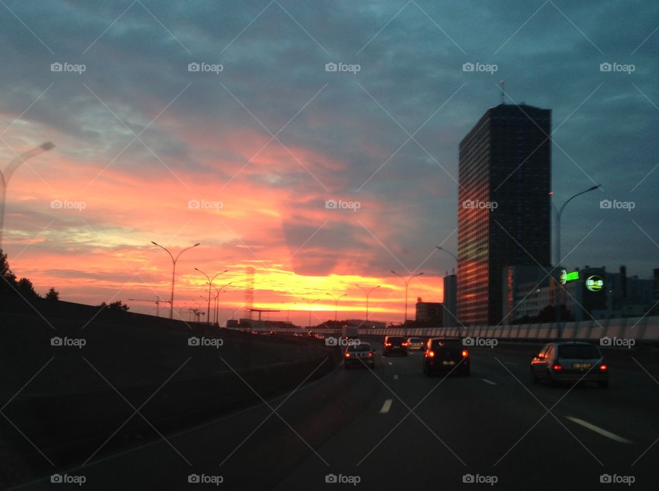 Sunset over the city . Sunset over the city and motorway 