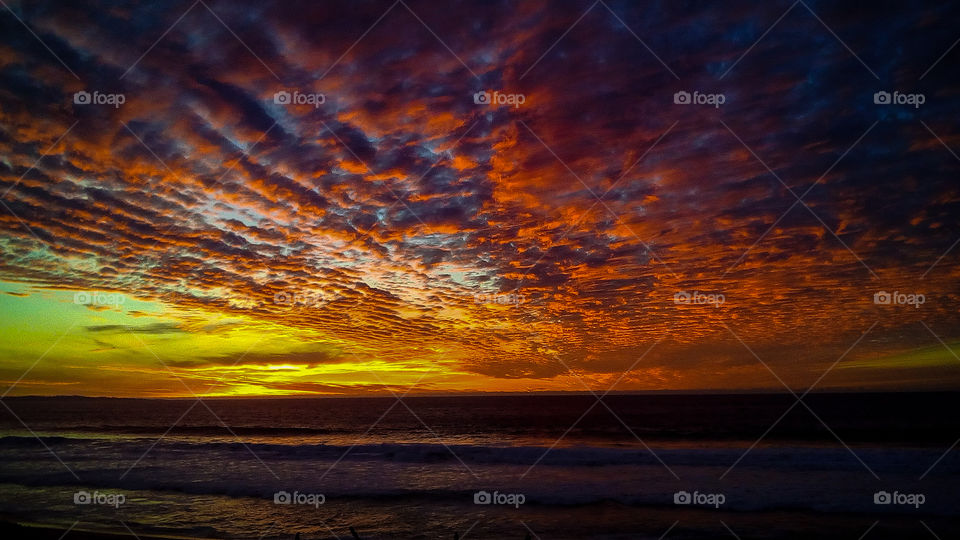 Amazing vibrant colorful sunset over the ocean in Monterey, California.