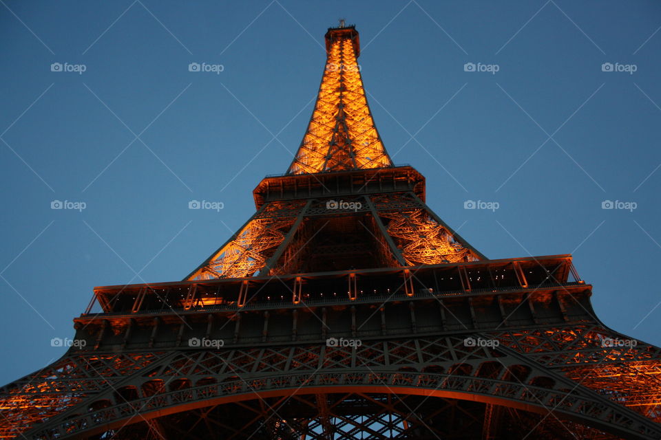 View from below Eiffel Tower in Paris by night