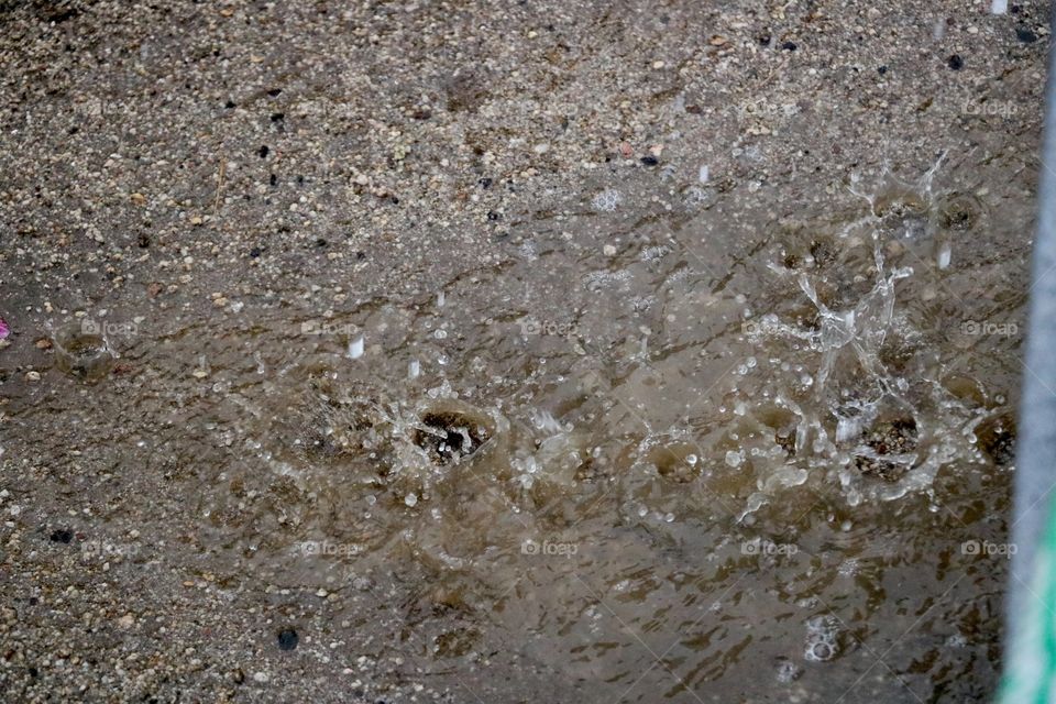 Water drops hitting the sand