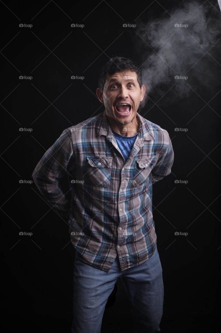 A gentleman of Puerto Rican decent has a little too much fun with the hand-held fog machine. 