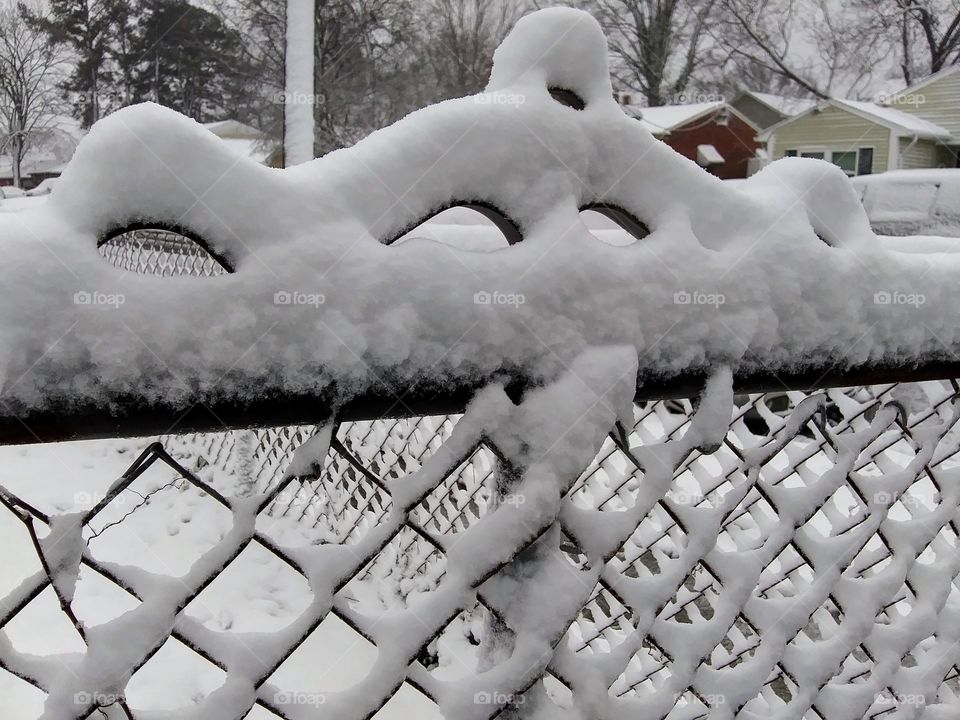 snow on the top of a gate