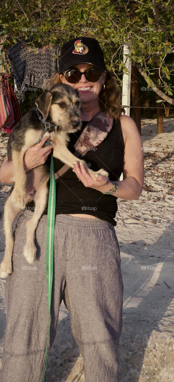 Volunteering at the Refugio Animal Holbox walking dogs on the beach.