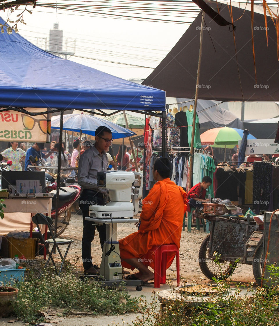 Monk at the walking oculist in Thailand
