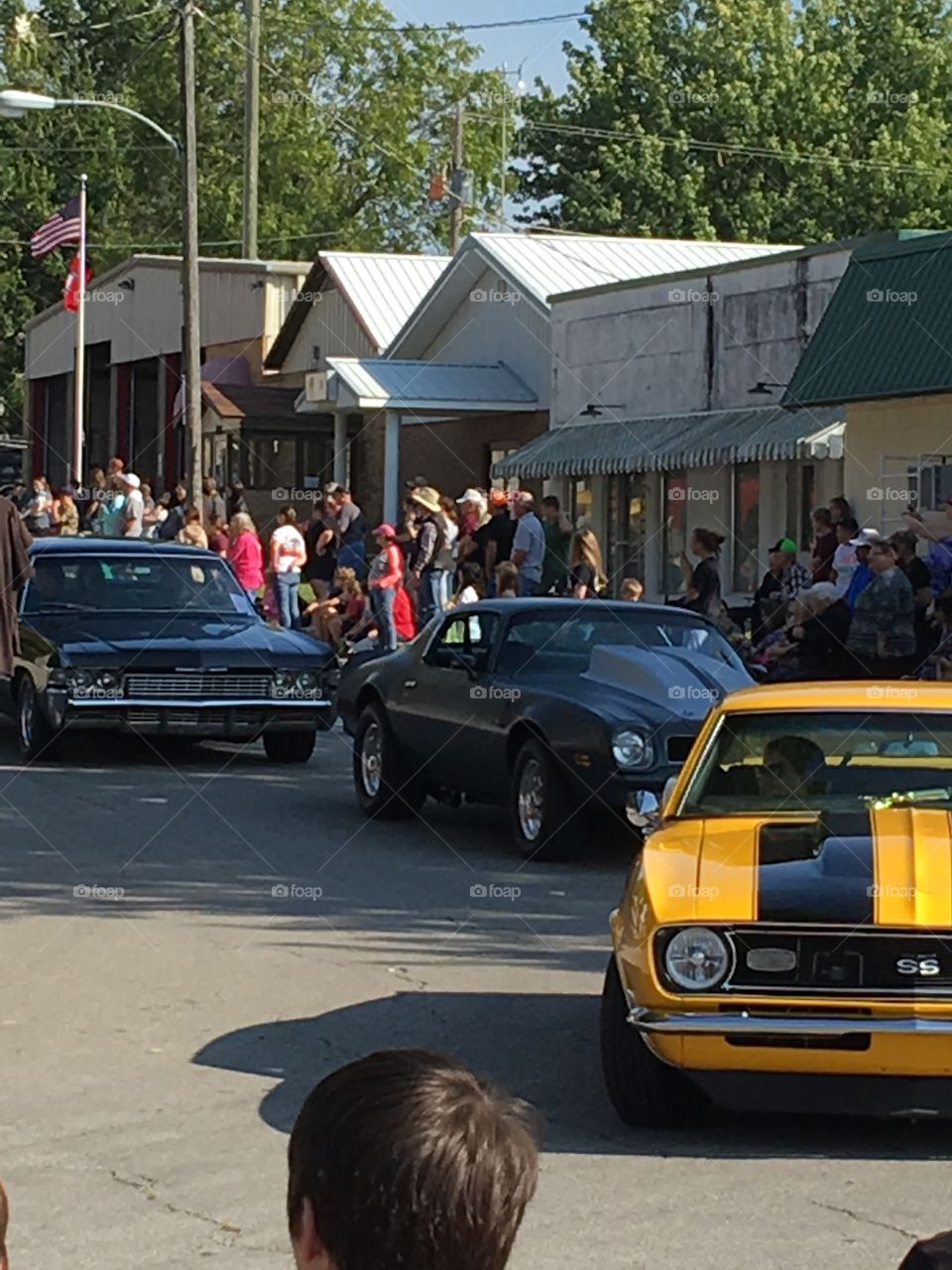 Apple festival parade here comes the sweet cars. Vroom vroom putt putt around the corner they go!
