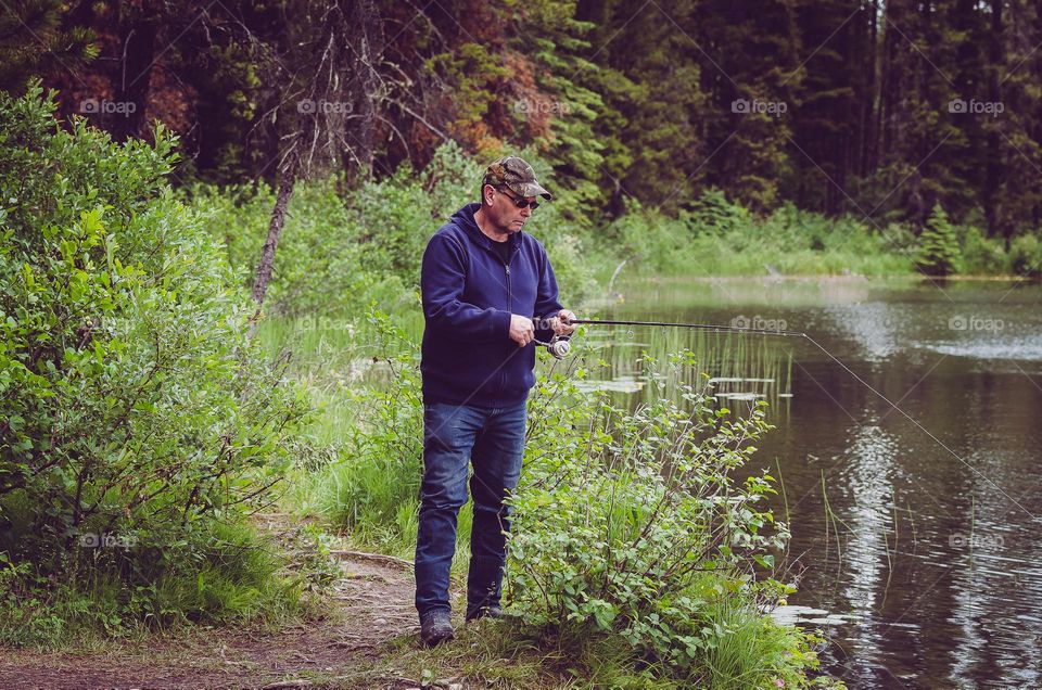 Man fishing alone on small lake 