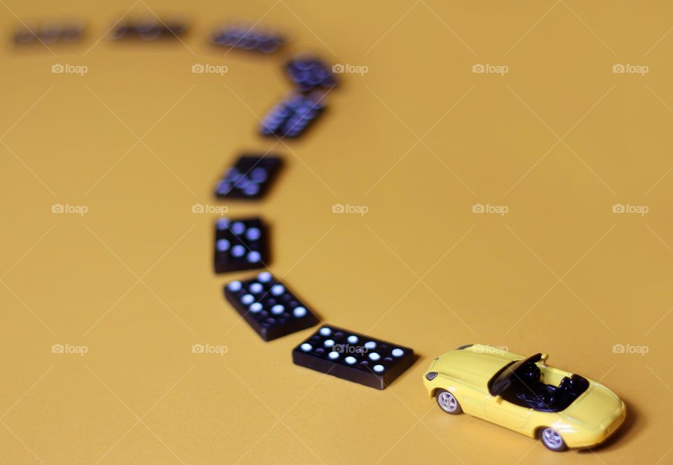 Rectangle shape of domino pieces and yellow toy car