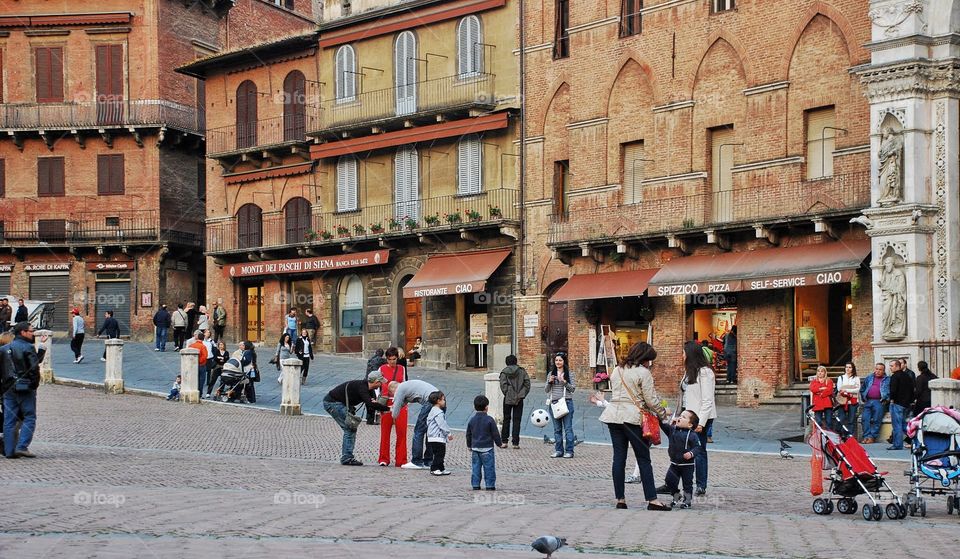 Street scene in sienna . The piazza in sienna Italy where people gather and socialize