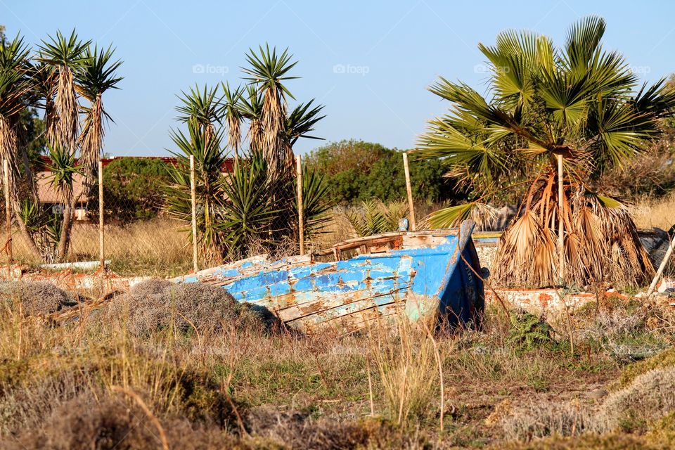 Wooden old fishing boat on land