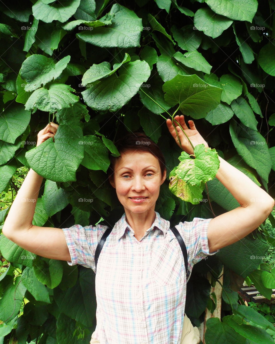 a woman in green leaves