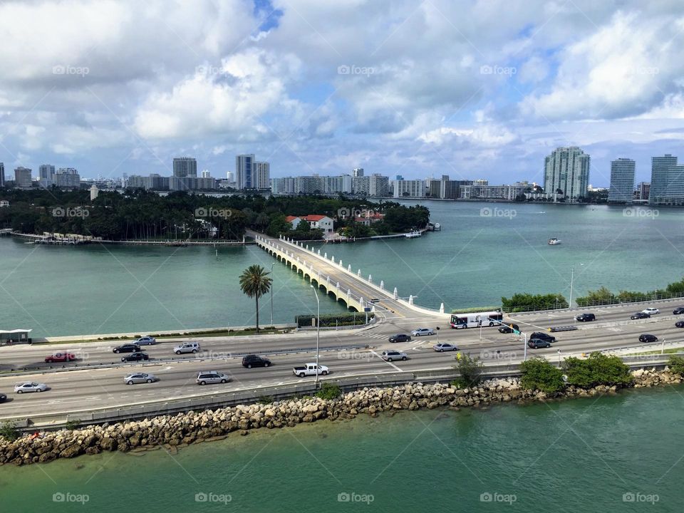 View to the Miami city details: ocean channel water, island, bridge and buildings