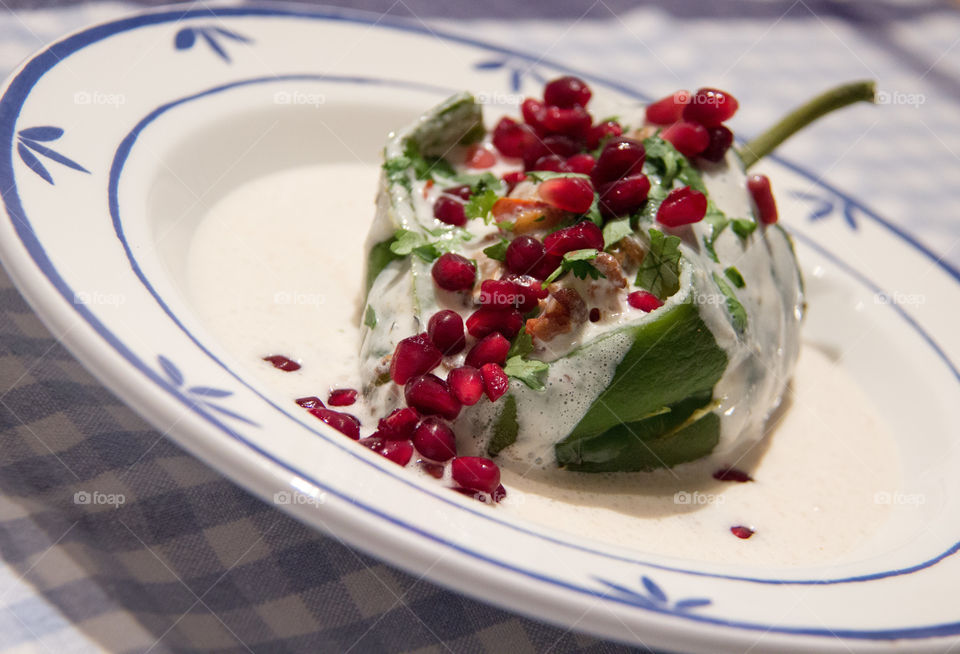 Stuffed poblano chilies with walnut sauce