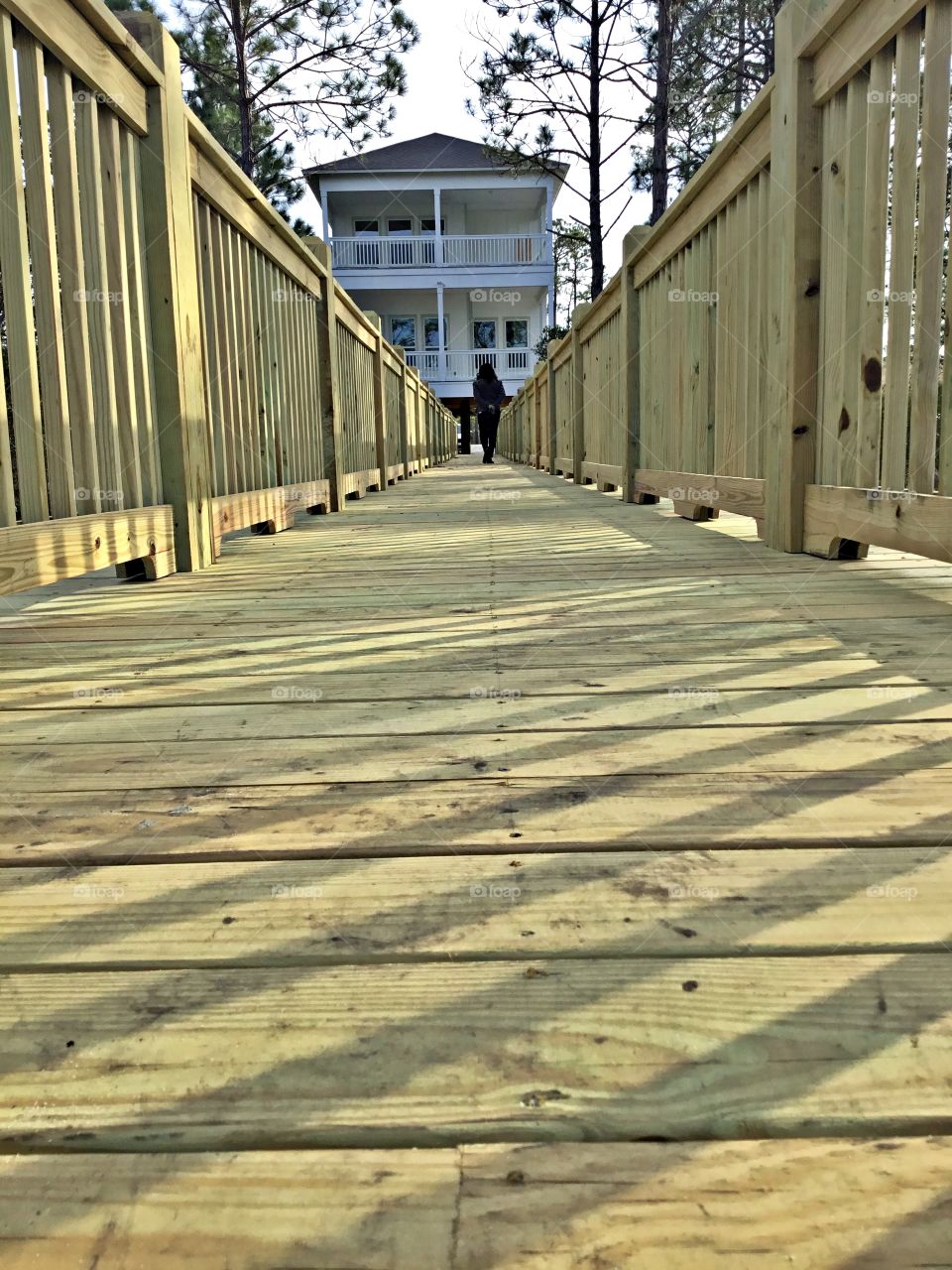 Symmetry - The planked walkway from the bay to the house offers a charm that only wood can bestow, from weathered sand & sea styles to polished modern renditions.