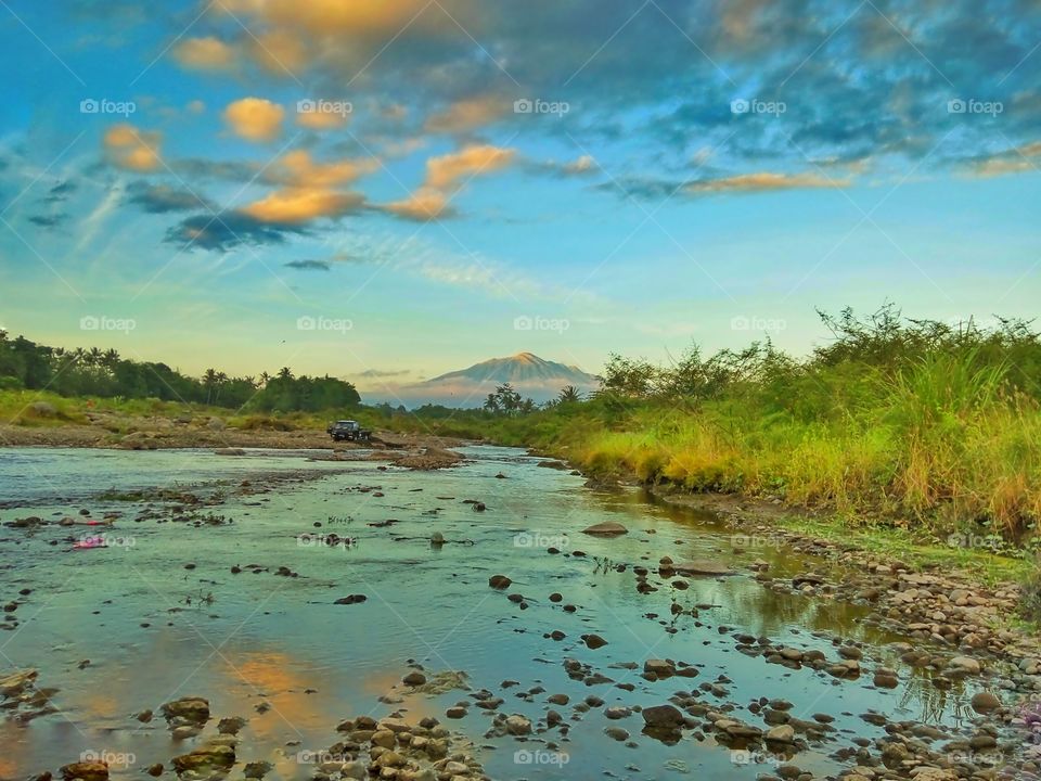 Sunset on The River
with the view of bright tip of Mount Merapi, and Reflection