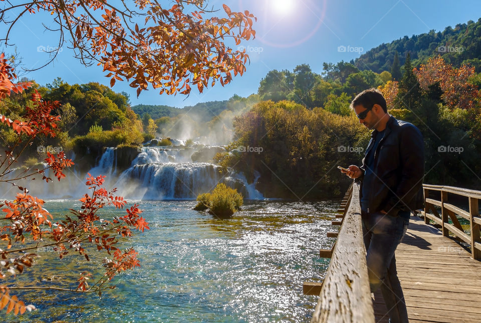 Man using mobile phone in beautiful nature