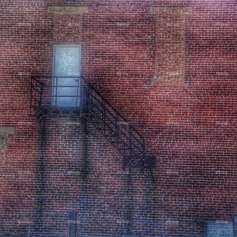 unique exterior stairway on old brick building
