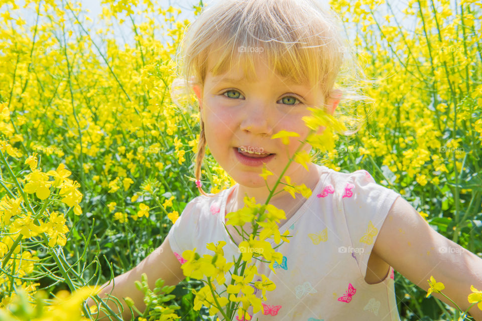 Close-up of a smiling girl in field