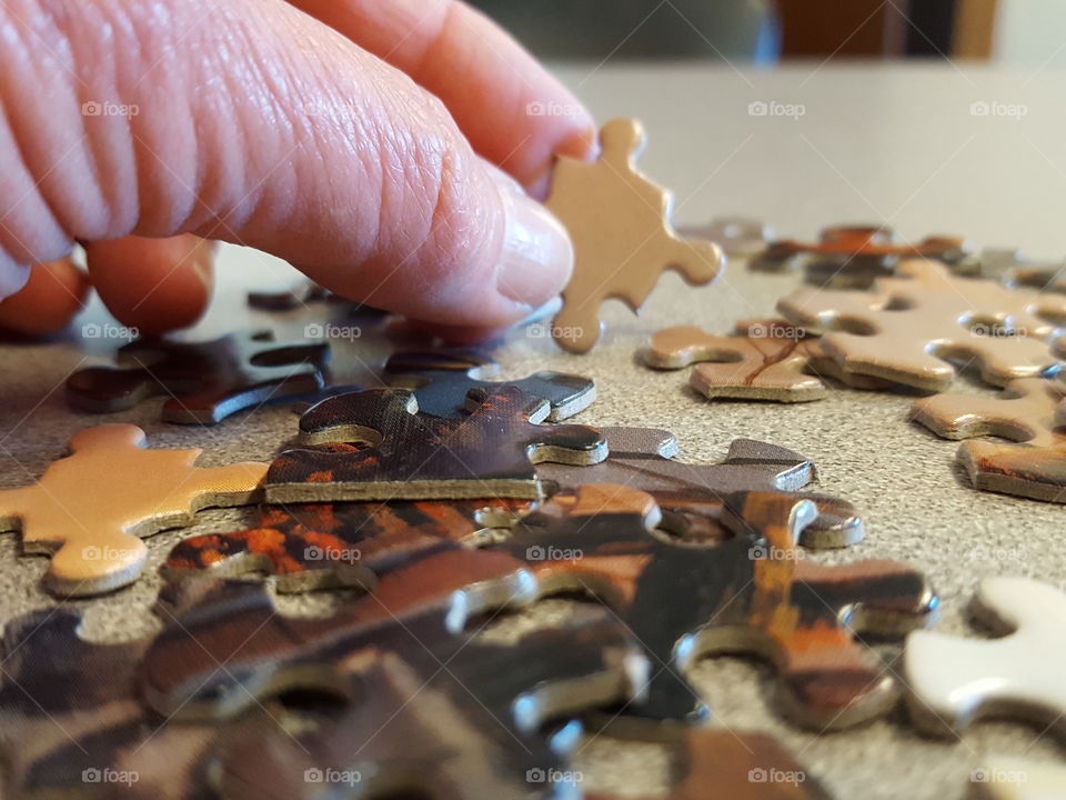 Man holding a jigsaw puzzle piece