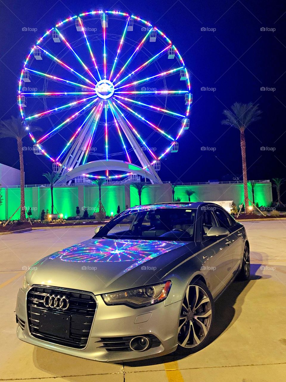 Cars with soul - 2014 Audi A6 4dr Sdn quattro 3.0L TDI Premium Plus with a reflection from a colorful Ferris Wheel 